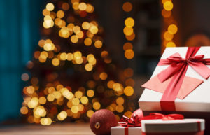 Beautiful,Christmas,Gifts,On,A,Table,At,Home,And,Tree