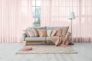 Grey,Sofa,With,Soft,Pillows,And,Lamp,Near,Big,Window