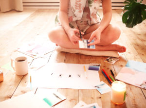 Young,Woman,Creating,Her,Feng,Shui,Wish,Map,Using,Scissors.