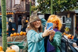 Two,Laughing,Female,Friends,In,Fun,Glasses,And,Witch,Hat