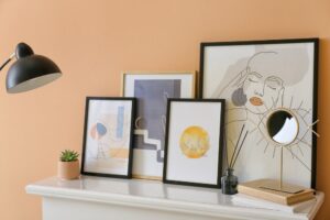 Stylish,Pictures,And,Mirror,On,Mantelpiece,Near,Color,Wall