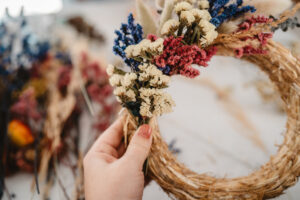Girl,Making,Floral,Door,Wreath,From,Colorful,Dry,Summer,Flowers