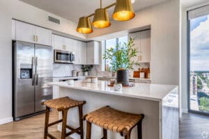 interior photo of kitchen with large island and fridge