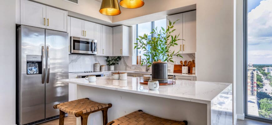 interior photo of kitchen with large island and fridge