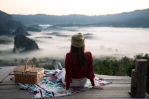 Solo,Traveler,Is,Relaxing,On,Balcony,Surrounded,By,Green,Forest